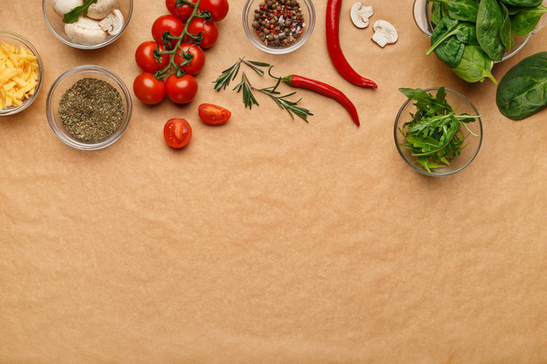 Ingredients and spices for homemade pizza on wooden table - Photo, Image