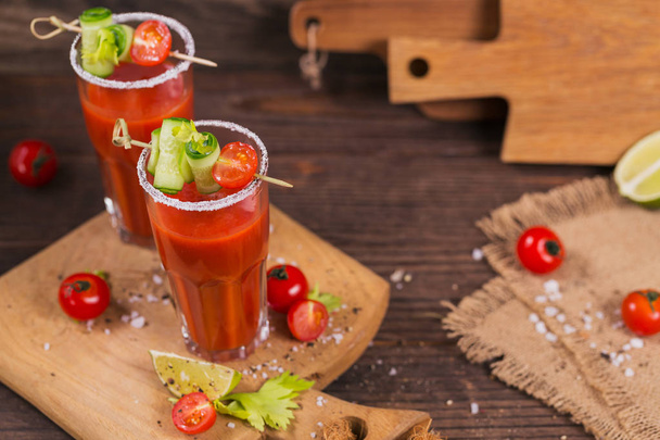 Two glasses of tomato juice decorated with fresh tomatoes, cucum - Φωτογραφία, εικόνα