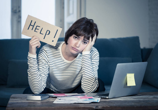 Portrait of worried young woman feeling stressed and desperate asking for help in paying bills, debts, tax expenses and accounting home finances with laptop. In online banking and financial problems. - Foto, imagen