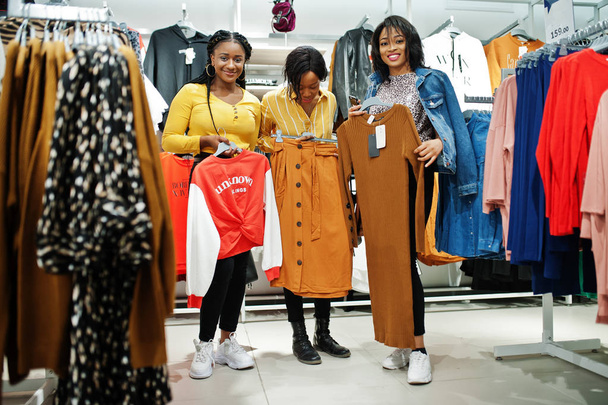 Three african woman choosing clothes at store. Shopping day.  - Foto, imagen