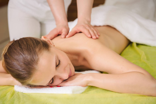 Woman enjoying classical neck and shoulder massage - Foto, afbeelding