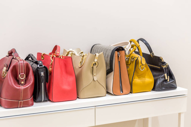Collection of handbags standing in a row - Valokuva, kuva