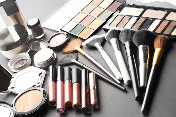 Multiple cosmetic products on black background. High resolution image for cosmetics and fashion industry. - Photo, Image