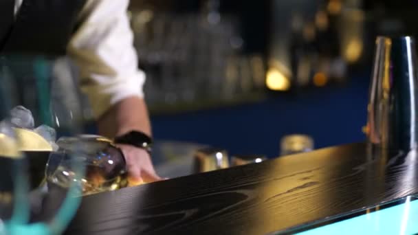 Barman hands putting ice in glass on bar counter - Footage, Video