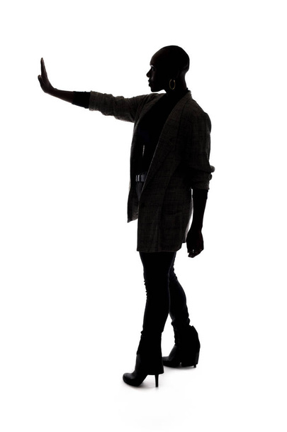 Black female African American model silhouette on a white background.  She is holding hands up in a stop gesture - Photo, Image