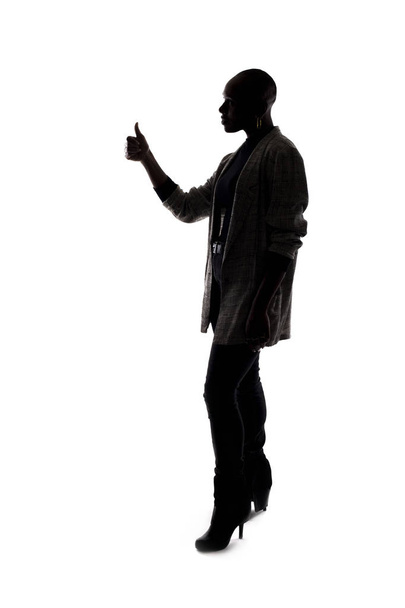 Black female African American model silhouette on a white background.  She is holding thumbs up in approval - Photo, Image