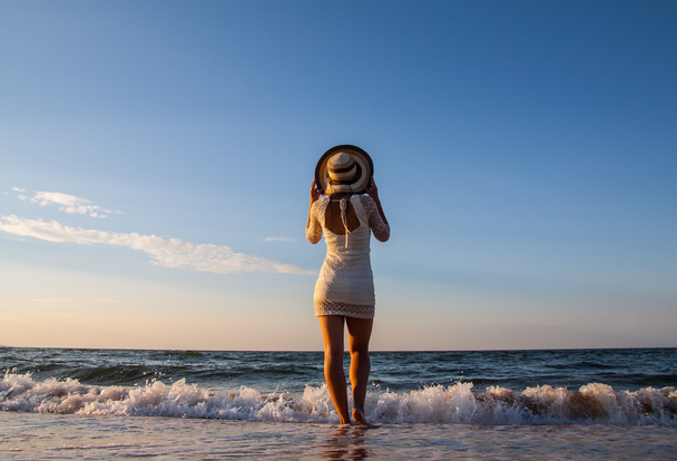 Young woman standing in sea looking ahead - Фото, зображення