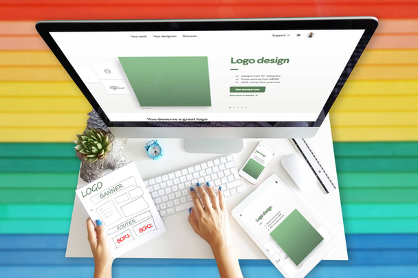 Responsive web design development with computer and different equipment on rainbow background - Photo, Image