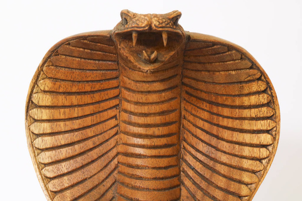 Close-up of a wooden statuette of a cobra, white background, collectibles - Photo, Image