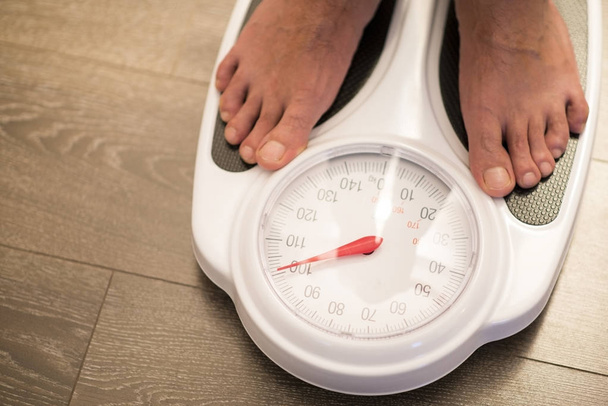 Obese or overweight male on weigh scale - Photo, Image