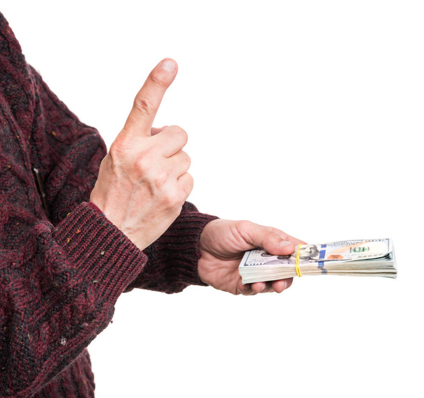Man Holding Pack van dollar biljetten - Foto, afbeelding