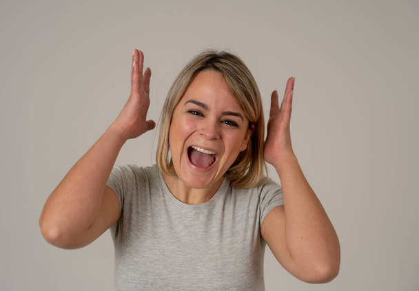 Portrait of beautiful shocked woman winning the lottery or having great success with surprised and happy face and gestures. In People, Facial Expression, Human Emotions and celebration. Studio shot. - Foto, Imagen