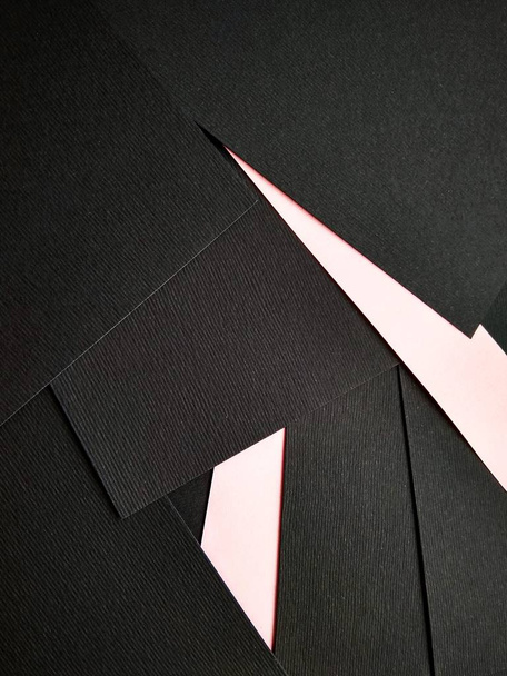 few black papers folded with color paper close up - Photo, Image