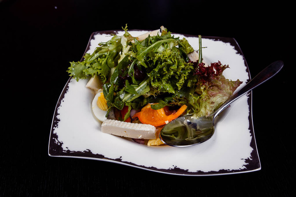 Salad with egg, red pepper, cheese and tomato served on a plate. - Photo, Image