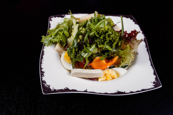 Salad with egg, red pepper, cheese and tomato served on a plate. - Fotografie, Obrázek