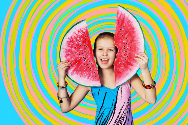 Funny summer portrait girl with watermelon. Child model in swimsuit posing in studio on colorful, rainbow background. Emotional, joyful face Caucasian kid. - Foto, Imagen