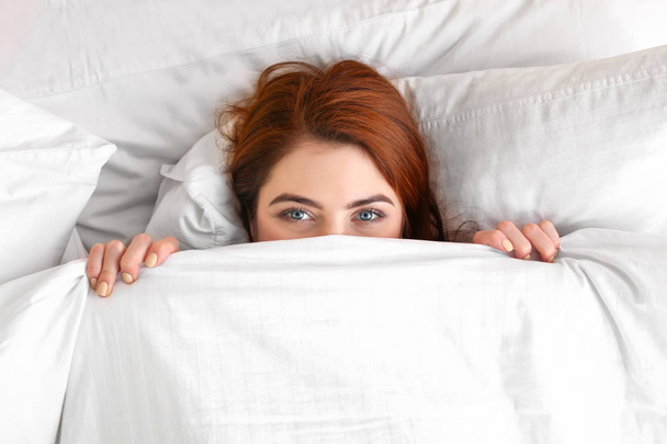 Morning of beautiful young woman lying in bed - Фото, зображення