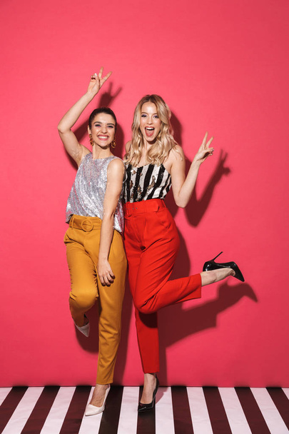Full length photo of two adorable women 20s in trendy outfit smi - Foto, immagini