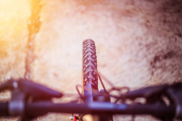 Mountain bike tyres outside, blurry handlebar, summer day, city  - Φωτογραφία, εικόνα