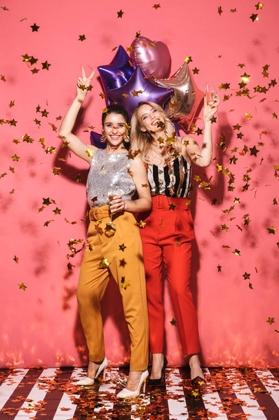 Photo of two glamour women 20s in stylish outfit holding festive - Zdjęcie, obraz