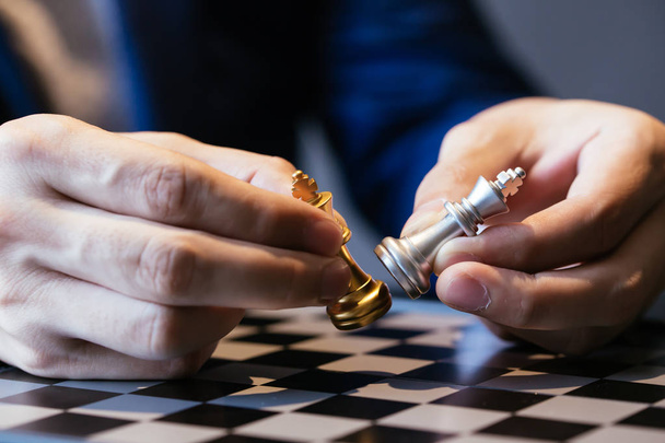 Cropped image of businessman made chess pieces fight - Photo, Image