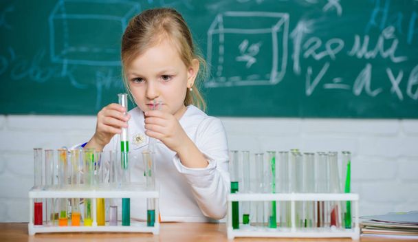 Future scientist. Explore and investigate. School lesson. Interesting approach to learn. Girl cute school pupil play with test tubes and colorful liquids. School chemical experiment. School education - Photo, Image