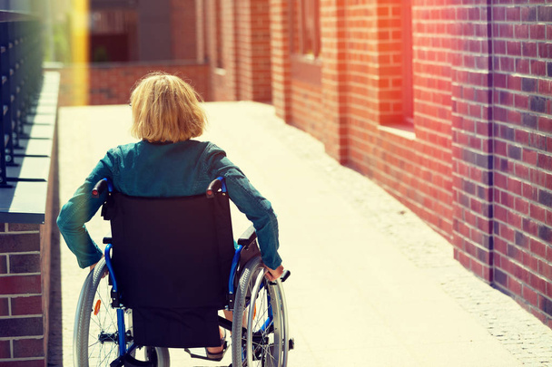 woman on wheelchair entering the platform - Foto, immagini