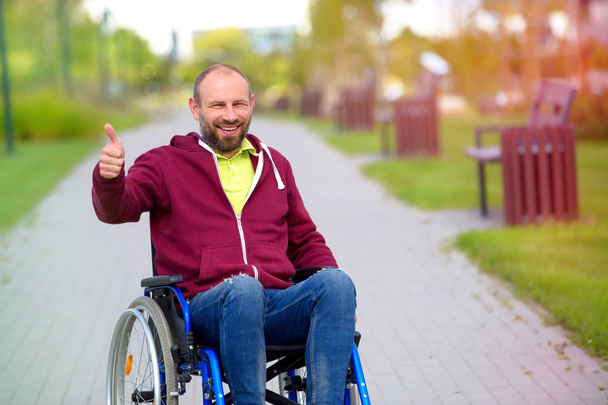 happy man on wheelchair showing OK - Фото, зображення