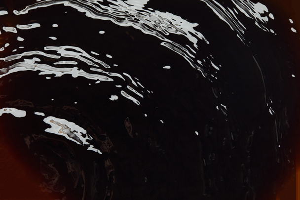 Close up view of dark background with liquid texture - Fotografie, Obrázek