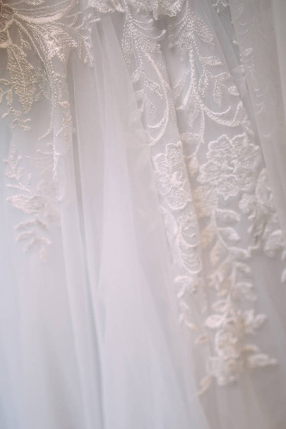 elegant lace on white wedding dress detail  - Foto, Imagen