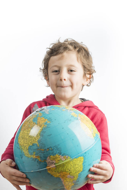 Child holding a globe in his arms. - Photo, image