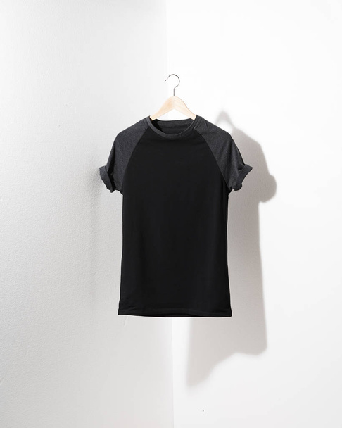 Front view of American Hipsters retro classic tshirt clothes. Blank template of vintage t-shirt hanging on a hanger on white background - Φωτογραφία, εικόνα