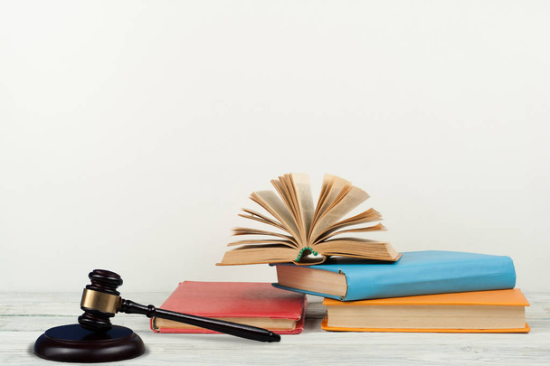 Law concept open book with wooden judges gavel on table in a courtroom or law enforcement office, white background. Copy space for text - Zdjęcie, obraz