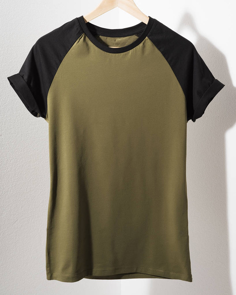 Front view of American Hipsters retro classic tshirt clothes. Blank template of vintage t-shirt hanging on a hanger on white background. Closeup. - Φωτογραφία, εικόνα