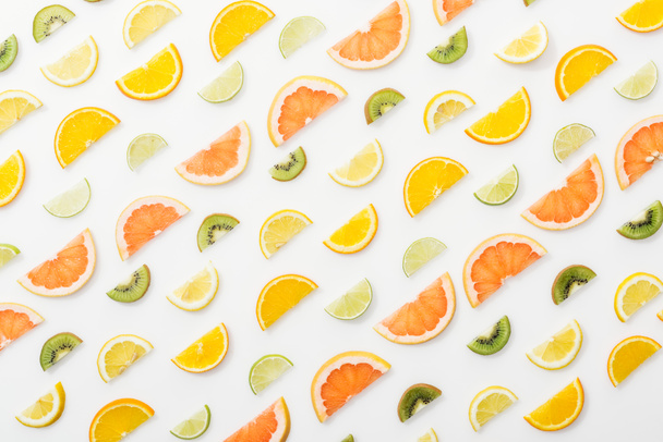 Flat lay with juicy cut fruits on white surface - Fotoğraf, Görsel