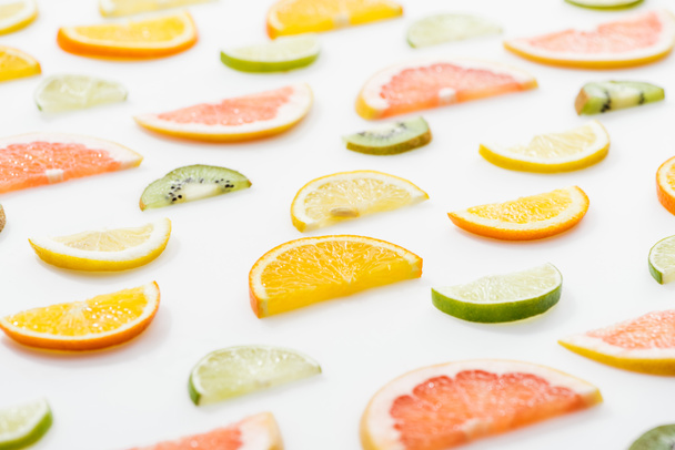 Juicy fresh sliced citrus fruits on white surface - Foto, afbeelding