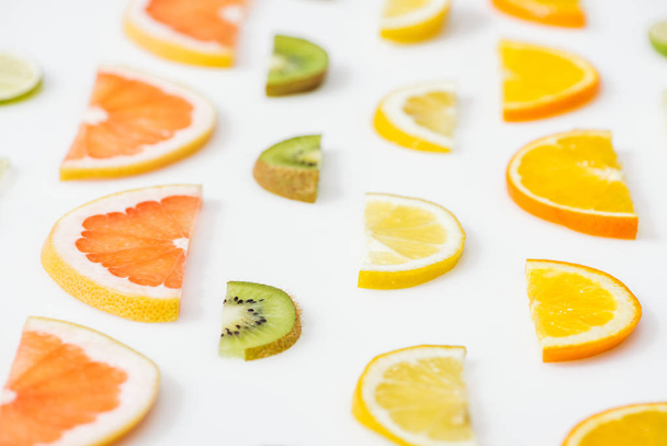 Juicy fresh sliced citrus fruits on white surface - Foto, Imagem