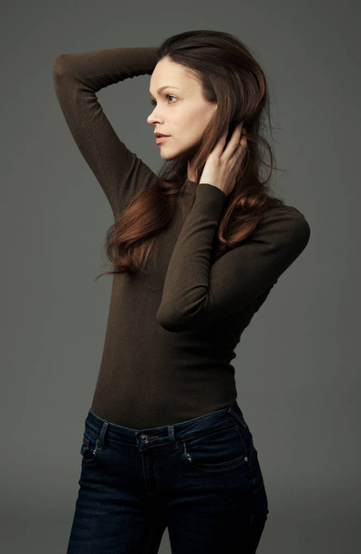 Pretty brunette woman with long hair looking away - Fotografie, Obrázek