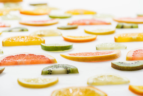 Juicy fresh sliced citrus fruits on white surface - Фото, зображення