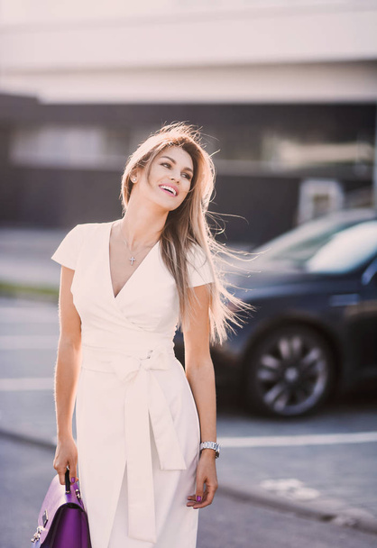 emotional spring summer portrait of Fashion stylish sexy of  young hipster blonde woman, elegant lady, bright colors dress, cool  girl. City view  urban lifestyle background. - 写真・画像