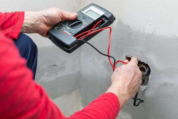 Electrician using voltmeter - Photo, image