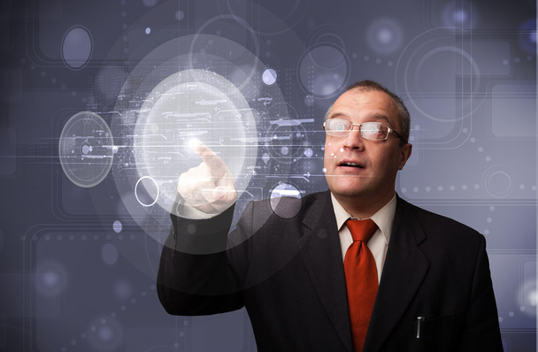 Бізнесмен торкається абстрактних високотехнологічних круглих кнопок
 - Фото, зображення