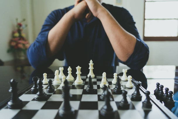 Holding a király sakk üzletember kerül egy chessboard.using - Fotó, kép