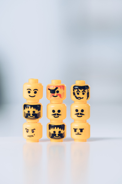 KYIV, UKRAINE - MARCH 15, 2019: yellow heads of lego figurines with various faces in rows - Fotografie, Obrázek