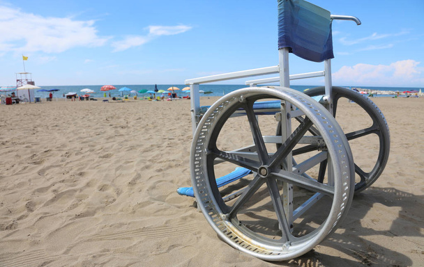 special wheelchair on the sandy beach - Photo, Image
