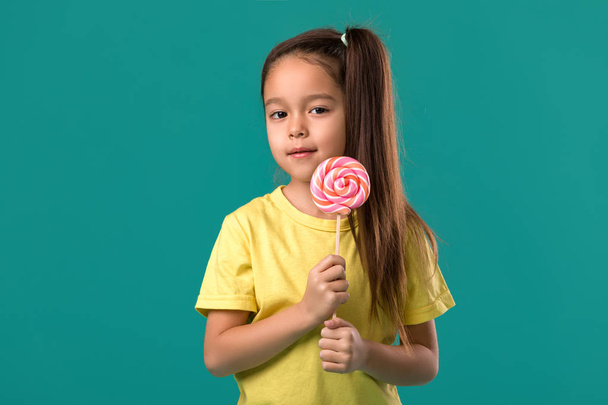 Beautiful cute little girl with a lollipop - Φωτογραφία, εικόνα