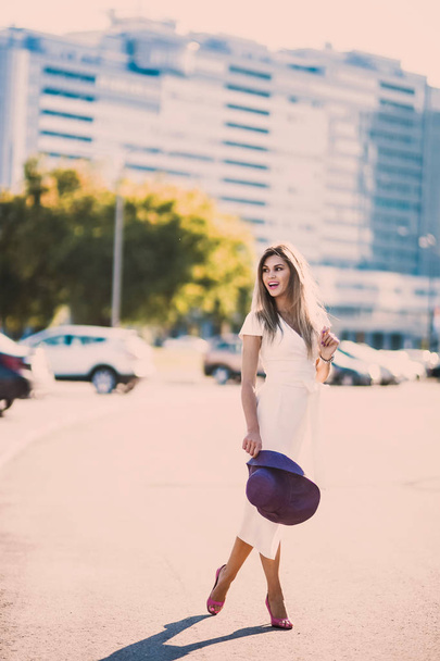 emotional spring summer portrait of Fashion stylish sexy of  young hipster blonde woman, elegant lady, bright colors dress, cool  girl. City view  urban lifestyle background. - Foto, imagen