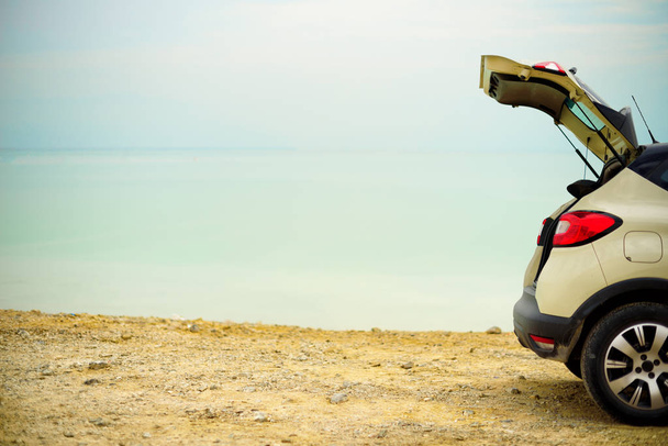Summer vacation, holidays, travel, trip, adventure concept. White crossover car on beach road. Banner. Digital detox. - Φωτογραφία, εικόνα