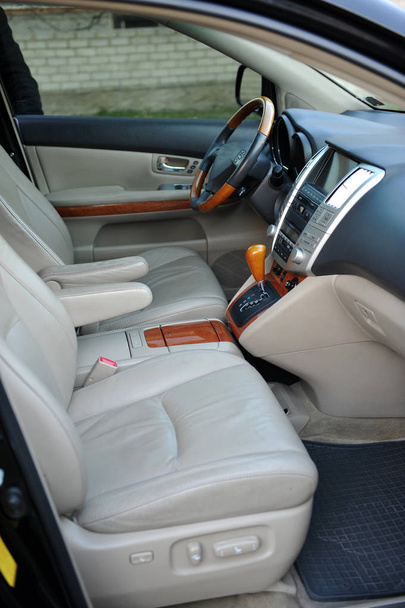Modern luxury prestige car interior, dashboard, steering wheel. Perforated leather, wooden interior. - Фото, зображення