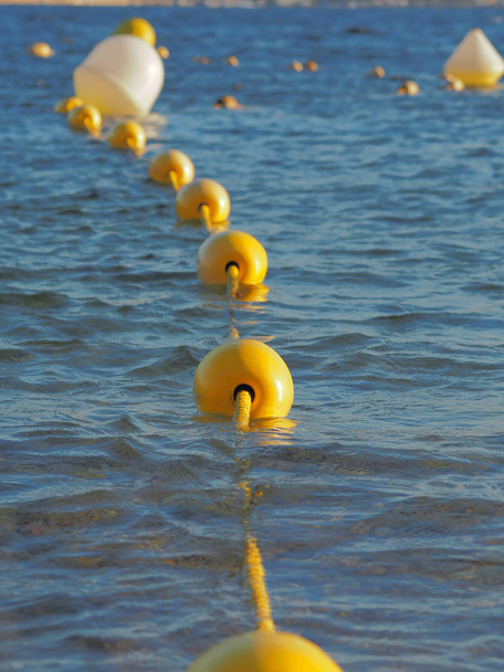 A close up of several buoys in the water. - Photo, Image